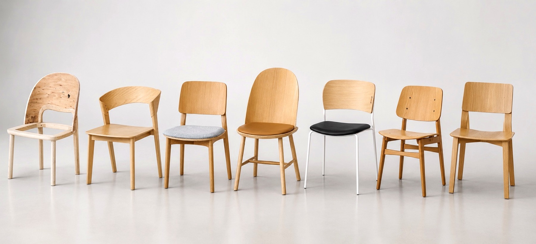 Modern dining chairs using curved plywood backs and molded plywood seating components.