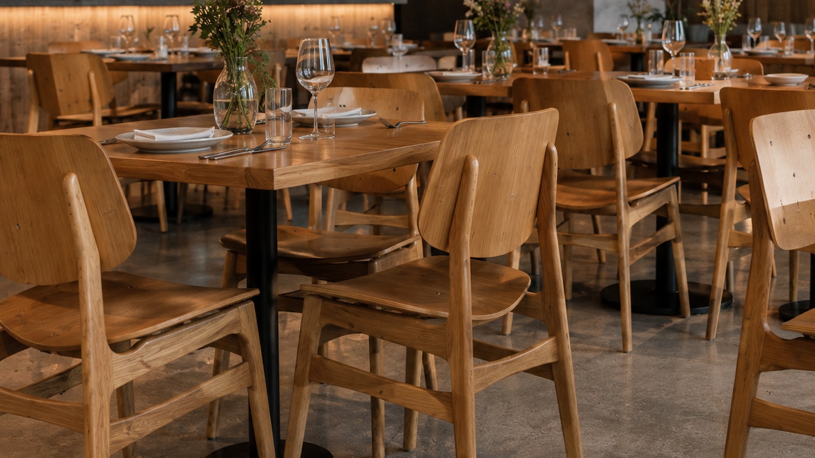 Wooden dining chairs used in a restaurant interior.