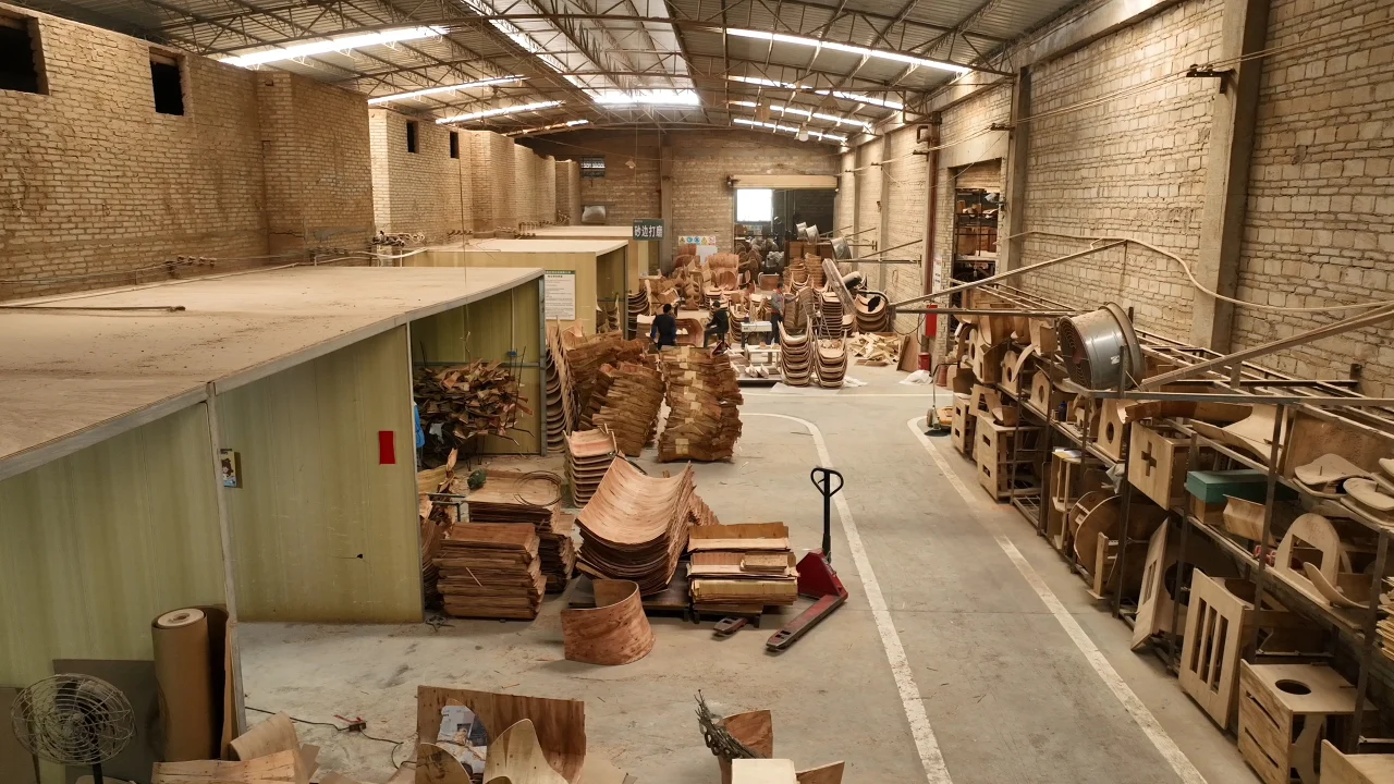 Dali Wood workshop with stacks of large curved plywood furniture components